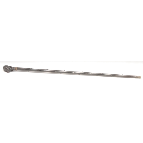 374 - An early 20th century novelty walking stick, the pommel carved as the head of a dog wearing a jockey... 