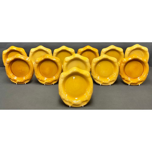 484 - A set of twelve Grandma Batty's treacle glazed novelty dishes or plates, as Yorkshire puddings, 27cm... 