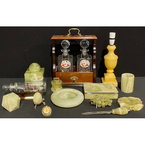 493 - A mahogany two bottle tantalus, cut glass canted square decanters, Mason's Ironstone decanter labels... 