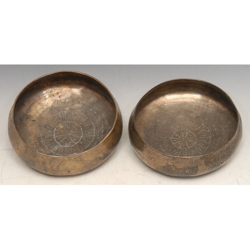 60 - A Burmese brass singing type bowl, engraved with a lotus, 12.5cm diam, 19th/early 20th century; anot... 