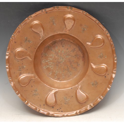 66 - A Middle Eastern copper shaped circular dish, repousse chased in the Islamic taste, 30cm diam, indis... 