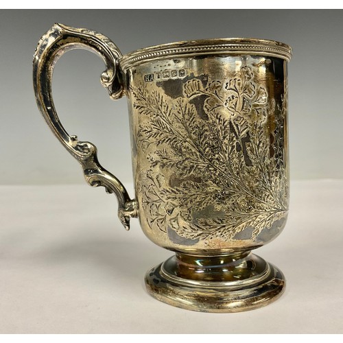 91 - A Victorian silver pedestal mug, chased with foliage, 10cm high, 112.3g, Sheffield 1874