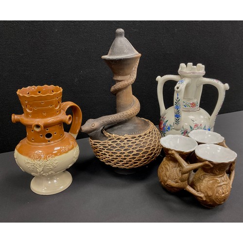 35 - Ceramics - a Denby Langley puzzle jug, a set of late 19th century fuddling cups, a 19th century hand... 