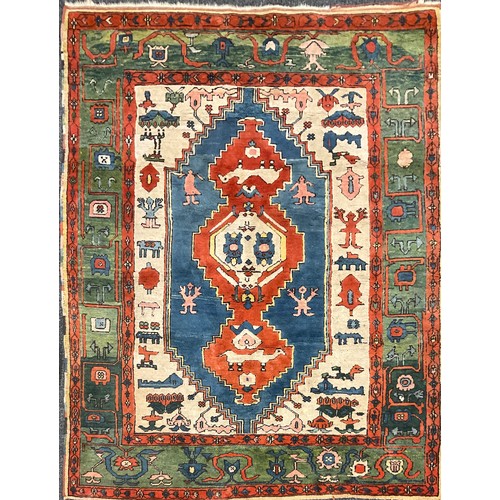 105 - A Turkish Konya rug, hand-knotted in tones of red, blue, green, and white, 247cm x 198 cm.