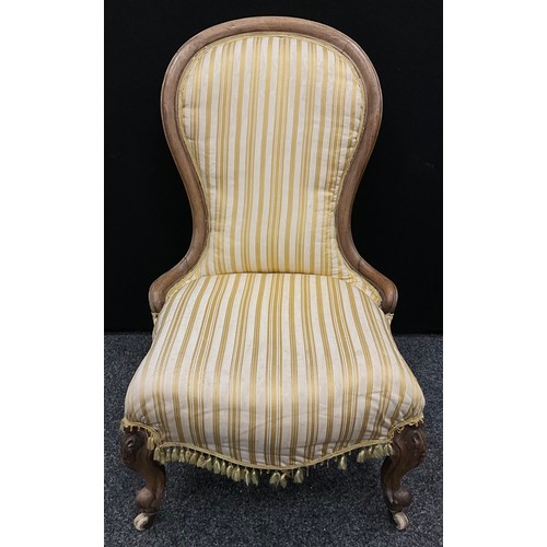 106 - A Victorian walnut spoon-back nursing chair.