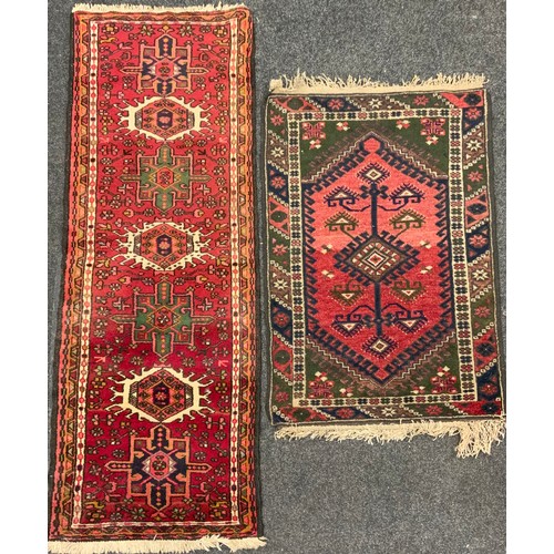 163 - A Persian Heriz type runner carpet, hand-knotted in tones of red, deep brown, white, and pink, 188cm... 