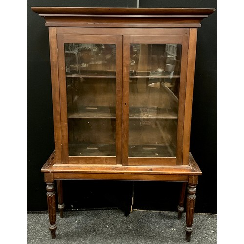 177 - A Victorian mahogany bookcase on stand, outswept cornice, pair of glazed doors enclosing two tiers o... 