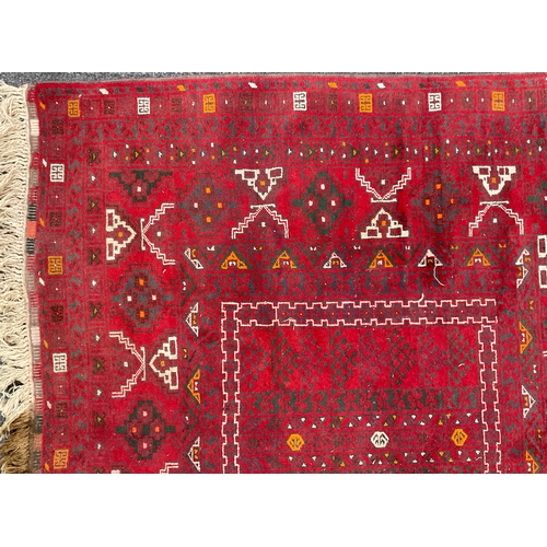 212 - A Turkaman Rug, hand-knotted, tones of red, grey, yellow, and white, 240cm x 165cm.