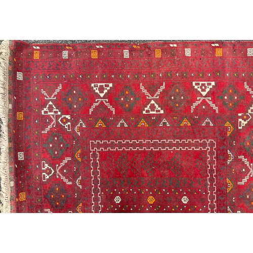 212 - A Turkaman Rug, hand-knotted, tones of red, grey, yellow, and white, 240cm x 165cm.