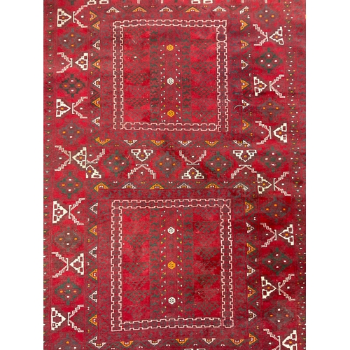 212 - A Turkaman Rug, hand-knotted, tones of red, grey, yellow, and white, 240cm x 165cm.