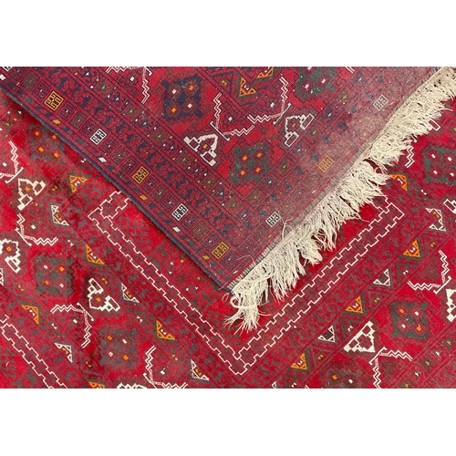 212 - A Turkaman Rug, hand-knotted, tones of red, grey, yellow, and white, 240cm x 165cm.