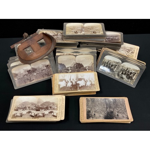 261 - A Hand-held stereoscopic viewer with approximately 200 stereoscopic slides, with subjects including ... 