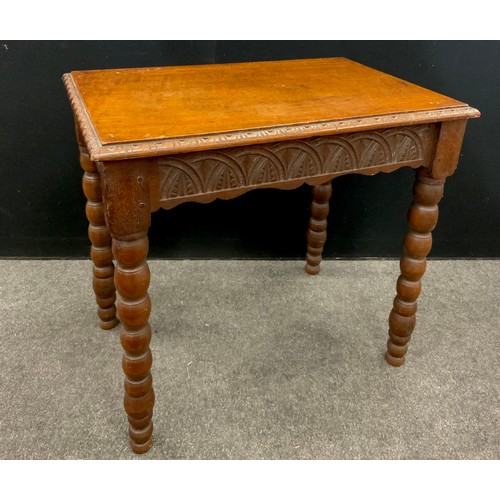 154 - A carved oak side table, early 20th century, Gothic style carved frieze, bobbin turned legs, 70cm hi... 