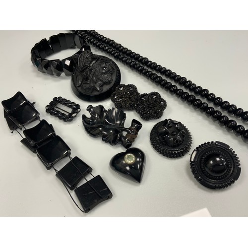 281 - Victorian Mourning jewellery - carved Whitby jet brooches, panel bracelet, shoe buckle etc inc Roman... 