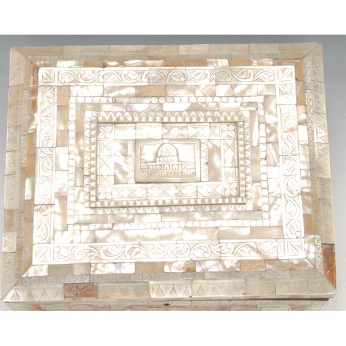 43 - A Middle Eastern mother of pearl veneered rectangular casket, the hinged cover centred by a depictio... 