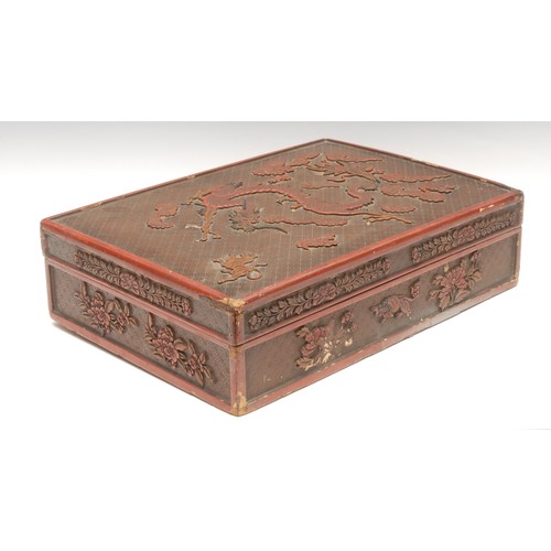 44 - A large Chinese rounded rectangular cinnabar lacquer box and cover, carved with dragon, tiger, phoen... 