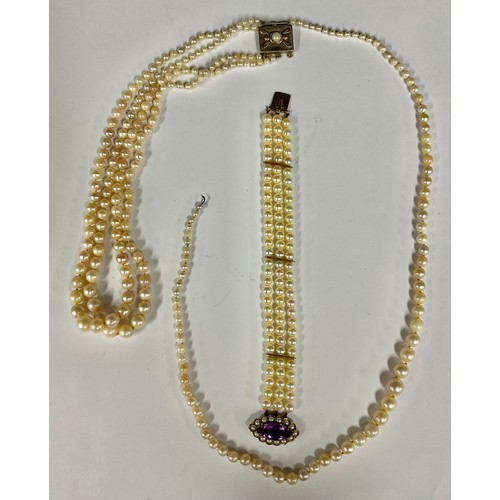 684 - A triple strand cultured pearl necklace, arranged with graduated irregular pearls, Secessionist styl... 