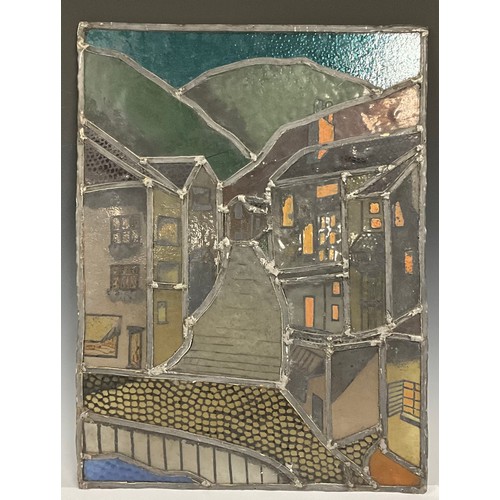 688 - A stained glass window, a street scene with rolling hills above, 63cm high, 47cm wide