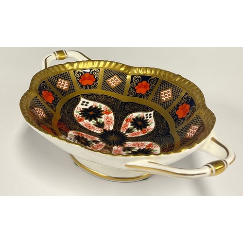 6 - A Royal Crown Derby 1128 old Imari solid band twin handled oval footed bowl, 22.4cm long, printed ma... 