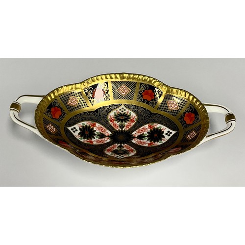 6 - A Royal Crown Derby 1128 old Imari solid band twin handled oval footed bowl, 22.4cm long, printed ma... 