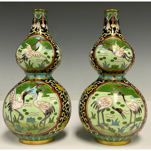 10 - A pair of Chinese cloisonne double gourd vases, decorated in polychrome enamels, with cranes in a la... 