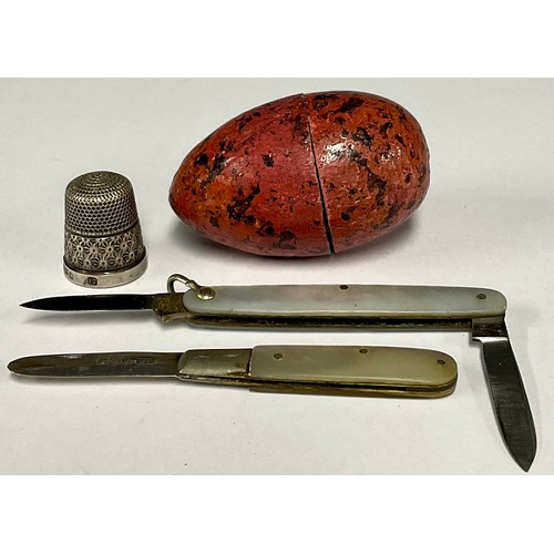 78 - A mother of pearl penknife, hallmarked silver blade; another ; a hallmarked silver thimble in egg ca... 