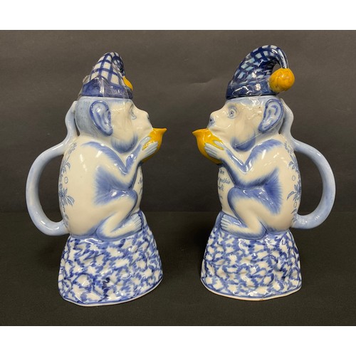 95 - A Dutch Delft jug and cover, in the form of a seated monkey, the cover as a hat with a bell, decorat... 