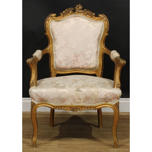 1612 - A pair of Louis XV Revival giltwood fauteuils, shaped cresting carved with scrolling leaves, stuffed... 