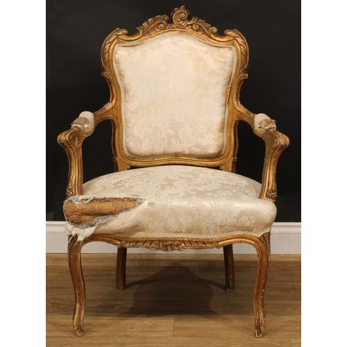 1612 - A pair of Louis XV Revival giltwood fauteuils, shaped cresting carved with scrolling leaves, stuffed... 