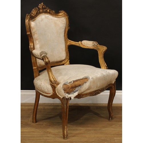 1612 - A pair of Louis XV Revival giltwood fauteuils, shaped cresting carved with scrolling leaves, stuffed... 