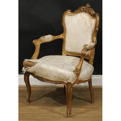 1612 - A pair of Louis XV Revival giltwood fauteuils, shaped cresting carved with scrolling leaves, stuffed... 