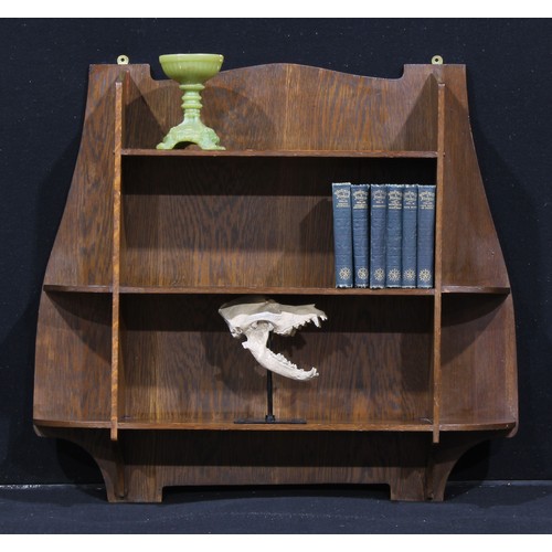 1563 - Liberty & Co - a set of Arts and Crafts oak 
wall shelves, 72cm high, 78cm wide, ivorine label to ve... 