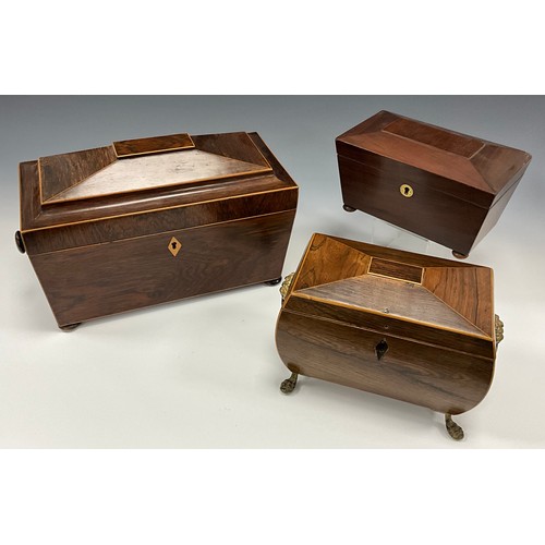 1807 - A 19th century rosewood Sarcophagus form tea caddy, hinged lid, two section fitted interior, lion ma... 