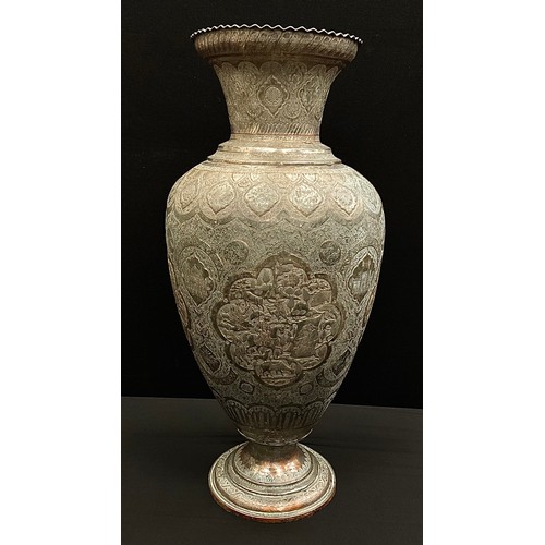 1418 - A large Persian silver coloured metal on copper floor vase, embossed and chased with panels of minst... 