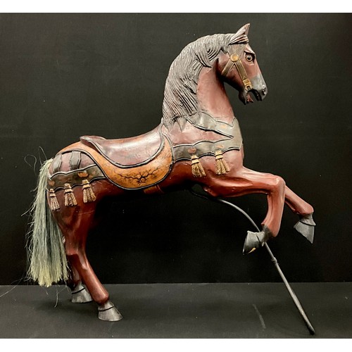 1572 - An early 20th century carved and painted Carousel horse, 105.5cm high, 104cm long,  25cm wide