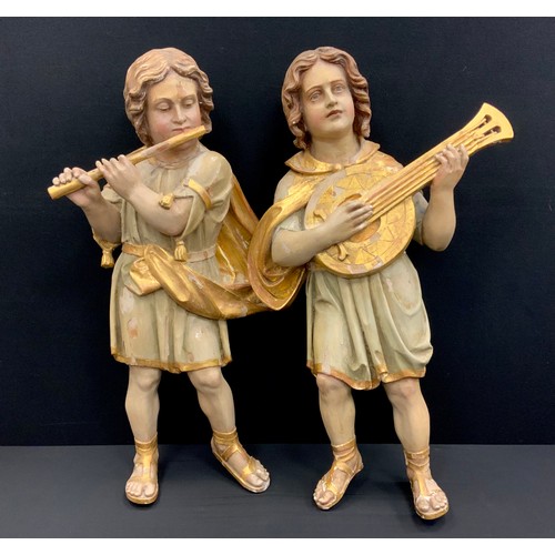 1844 - A pair of 19th century Continental polychrome figures,  standing, one playing a flute, the other a m... 