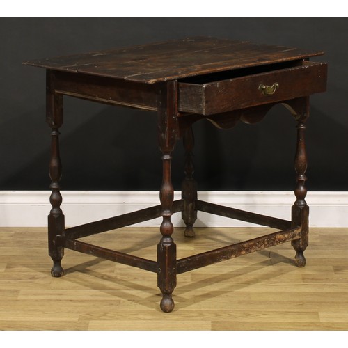 1569 - An early 18th century oak side table, oversailing rectangular top above a frieze drawer, shaped apro... 