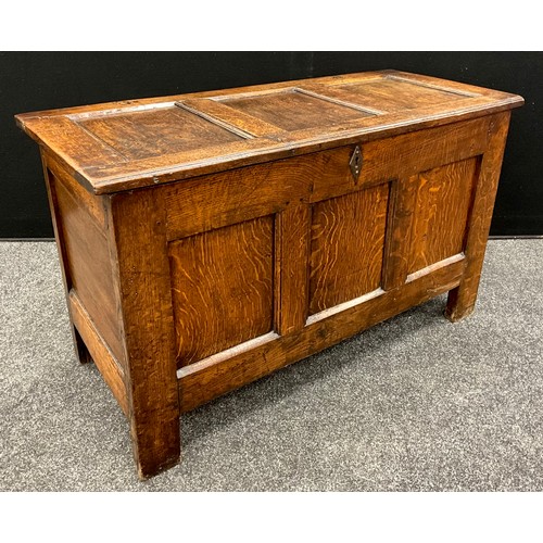 1928 - An 18th century three panel oak blanket chest, 61cm high, 103cm wide, 45cm deep