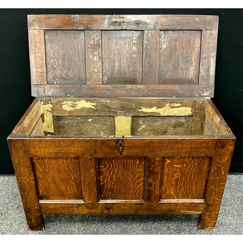 1928 - An 18th century three panel oak blanket chest, 61cm high, 103cm wide, 45cm deep