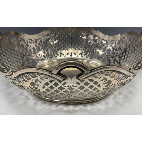 311 - A Dutch silver oval fruit basket, with pierced floral scroll work and lattice panelled sides, undula... 