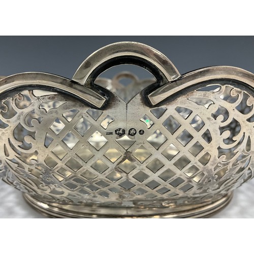 311 - A Dutch silver oval fruit basket, with pierced floral scroll work and lattice panelled sides, undula... 