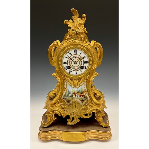 1715 - A 19th century French Ormolu and porcelain mantel clock, floral dial, Roman numerals, above landscap... 