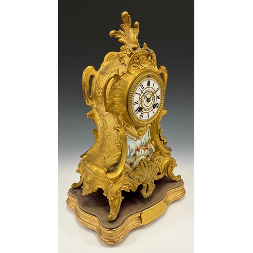 1715 - A 19th century French Ormolu and porcelain mantel clock, floral dial, Roman numerals, above landscap... 