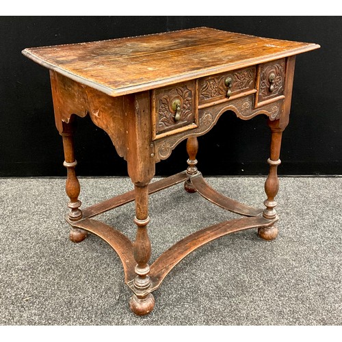 1895 - A George III oak lowboy, the over-sailing top above three drawers to the frieze, turned supports, sh... 