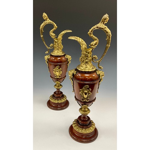 1851 - A pair of Continental gilt metal mounted turned walnut Cellini ewers, in the Renaissance Revival tas... 