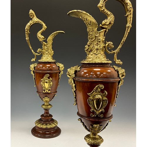 1851 - A pair of Continental gilt metal mounted turned walnut Cellini ewers, in the Renaissance Revival tas... 