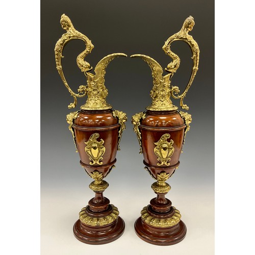 1851 - A pair of Continental gilt metal mounted turned walnut Cellini ewers, in the Renaissance Revival tas... 