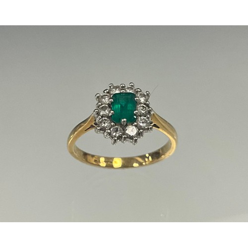 697 - An emerald and diamond cluster ring, cushion cut mid green emerald, 5.01mm x 3.64mm x 2.76mm, calcul... 