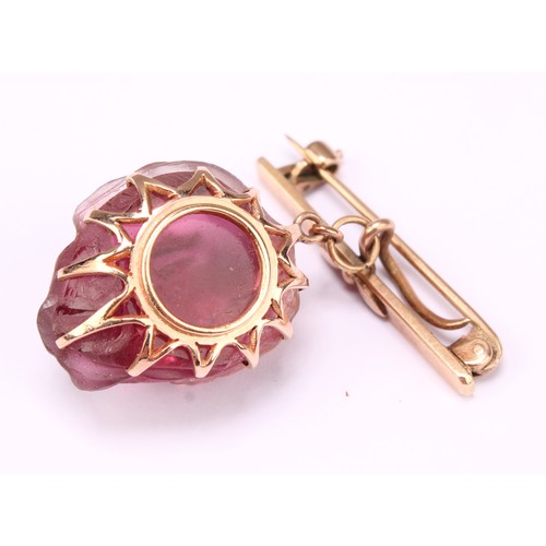 677 - Alfred Lyndhurst Pocock (1882 - 1962), a 9ct rose gold mounted amethyst brooch, carved in relief wit... 