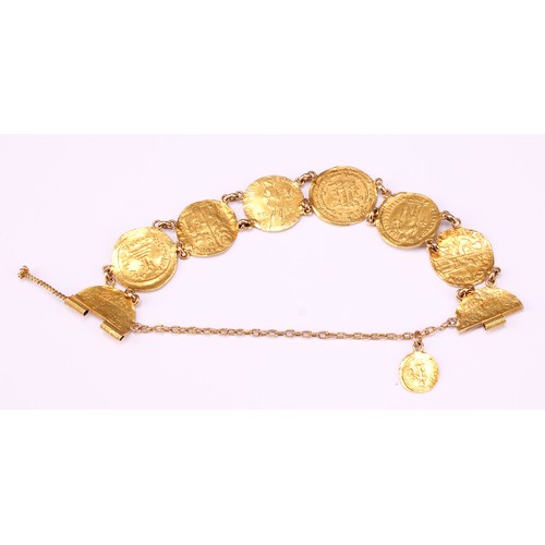 601 - A high carat gold bracelet, containing an arrangement of seven Byzantine and other similar gold coin... 